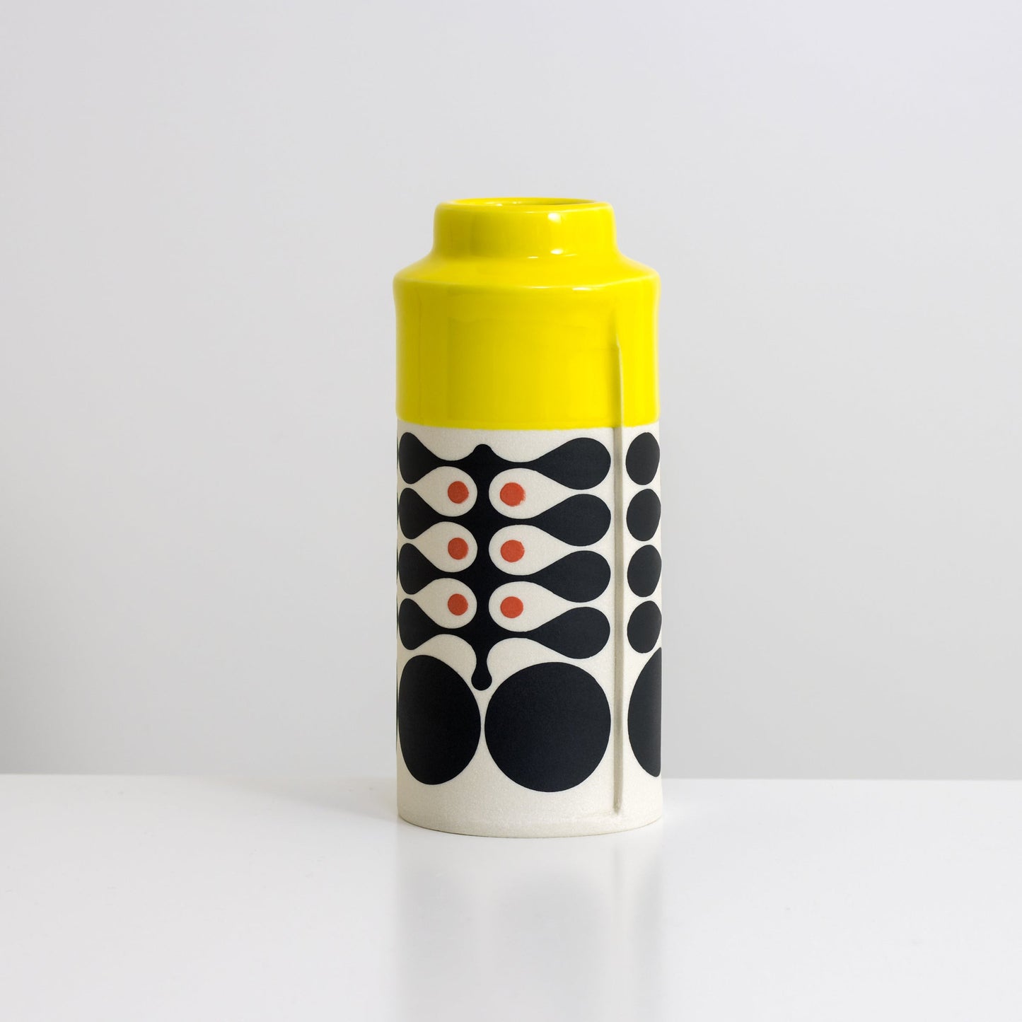 Cylinder with yellow glaze, vertical seaweed pattern in black